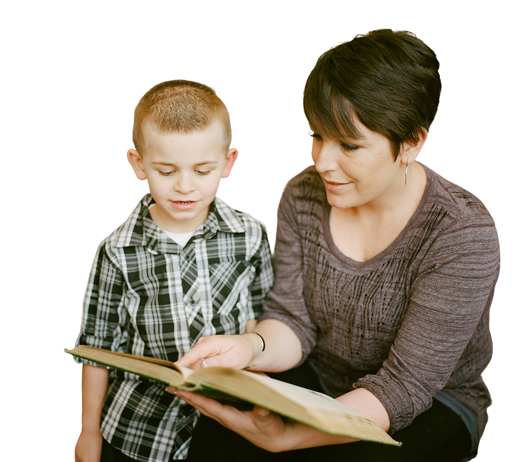 Woman and child reading a book together, with the child pointing at the page.